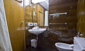 Bathroom features a sink, toilet, and towel rack.