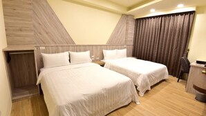 A hotel room with two beds, a wooden wardrobe, a desk, and a curtain. - Shui Yifang B&B (Magong)