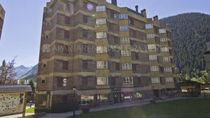 A multi-story building with a brick facade and multiple windows.
