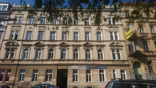 A multi-story building with a classic architectural style, featuring symmetrical windows and decorative moldings. - ABAI Hostel (Vienna)