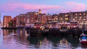 A waterfront cityscape with buildings and boats docked at the harbor. - Great Price;Beautiful, Spacious 3 Bed 2 Bath in a House Near Downtown Portsmouth (Portsmouth)