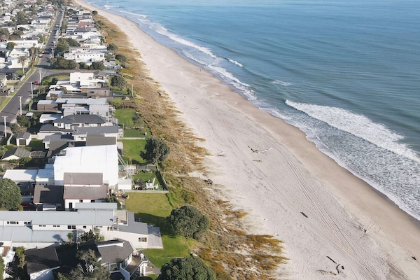 Charming beachfront retreat, 25m from shore, with private path.