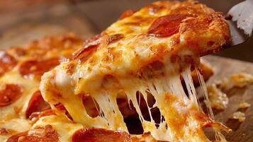 A close-up of a pizza with melted cheese and pepperoni.