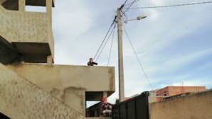 A building with a concrete facade, a black gate, and a visible staircase. - Cool view to downtown tunis (tunis)