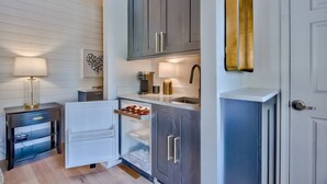 A compact kitchen with a refrigerator, a sink, and a countertop. - Beach Views on 30A! (Santa Rosa Beach)