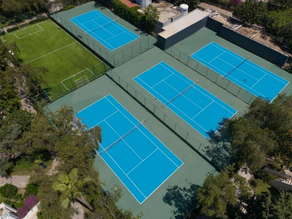 An aerial view of a sports complex with multiple tennis courts and a soccer field. - DoubleTree by Hilton Bodrum Işıl Club Resort (Bodrum)