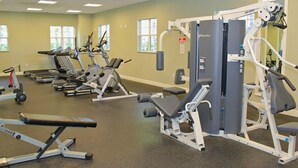 A gym with treadmills, elliptical machines, and weightlifting equipment.