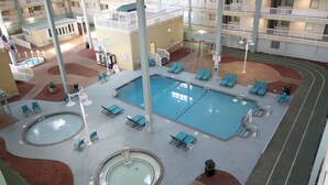 An indoor swimming pool area with multiple pools, lounge chairs, and a covered seating area. - Beach Access Villa with Indoor & Outdoor Pools - Private Balcony - Updated (Hilton Head Island)