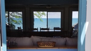 A room with a view of the sea, a checkered floor, and a window with a view.