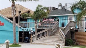A building with a sign reading "Palapa Bar & Restaurant" and a "GRILL" sign below it.