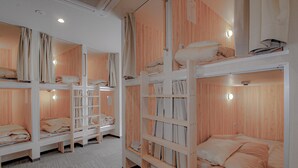 A room with bunk beds, wooden walls, and a tiled floor. - bnb+ Namba - Hostel (Osaka)