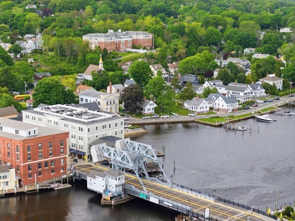 A river with a bridge, buildings, and boats.
