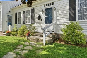 A white house with black shutters, a front door, and a small porch with steps. - Mystic Riverfront Captain`s Home (Groton)