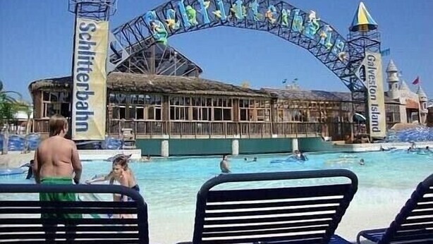 A swimming pool area with a large arched entrance labeled "Schilfterbahn" and "Galveston Island". - Beautiful Beach House with Gulf views, 2 min walk to Beach!!  (Galveston)