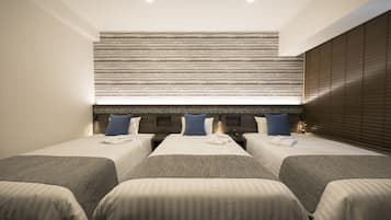 A hotel room with two beds, a large window with blinds, and a wooden headboard.