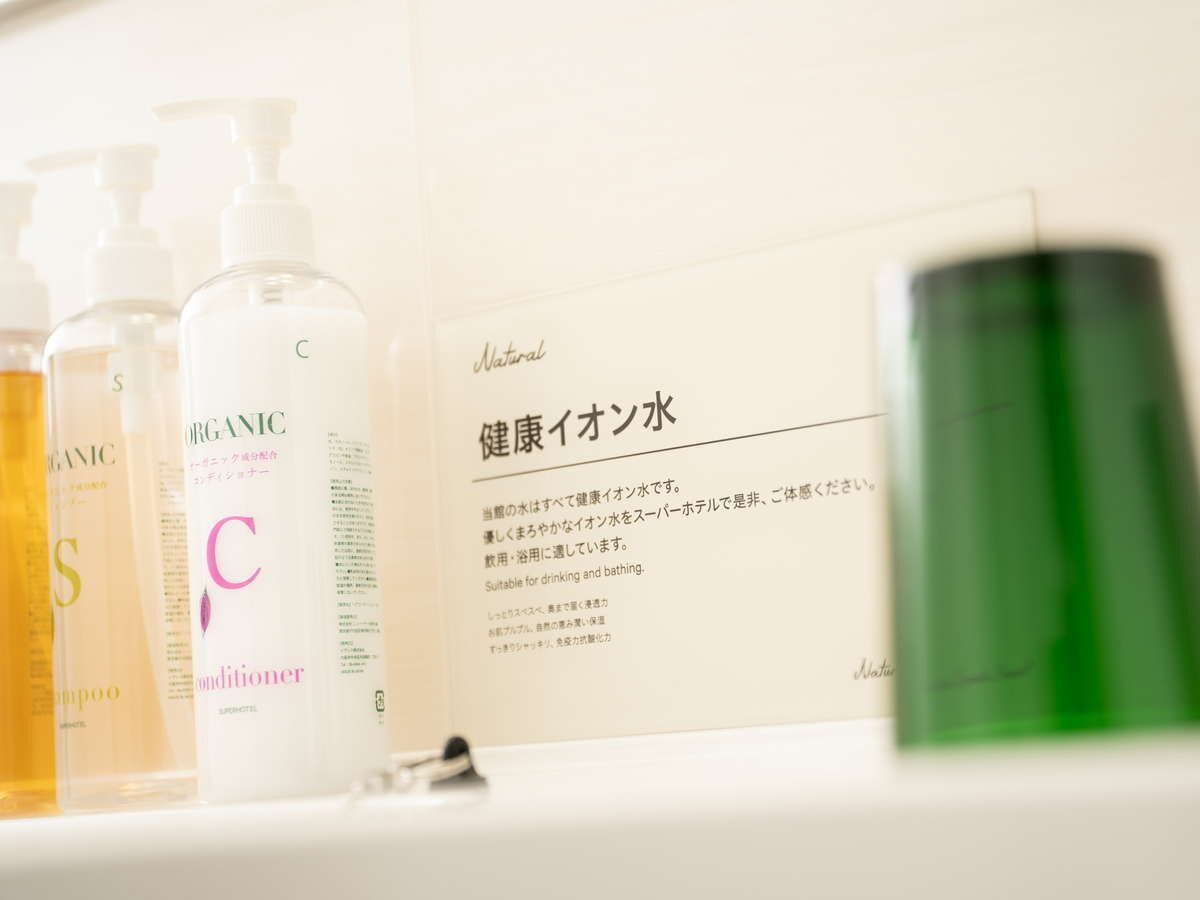A shelf with various skincare products, including a green bottle and a white box with Japanese text.