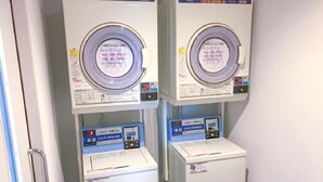 Two identical CO/N DRYER 45 machines with control panels and a CO/N WASHER below them. - Hotel Livemax Chiba Chuo Ekimae (Chiba)