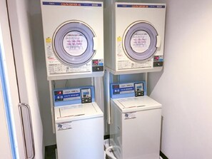 Two identical CO/N DRYER 45 machines with control panels and a CO/N WASHER below them. - Hotel Livemax Chiba Chuo Ekimae (Chiba)