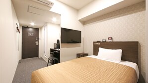 A hotel room with a bed, a desk, a TV, and an air conditioning unit. - Hotel Livemax Chiba Chuo Ekimae (Chiba)