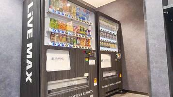 Two vending machines labeled 'LIVEMAX' in a hotel setting.