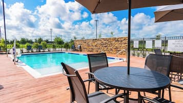 Outdoor pool, open 10:00 AM to 10:00 PM, pool umbrellas
