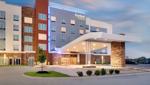 A Fairfield by Marriott hotel with a modern design, featuring a prominent entrance and a parking lot.