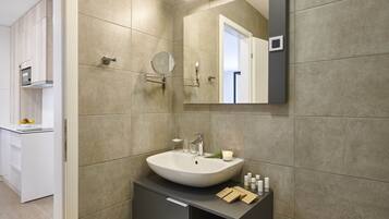 A modern bathroom with a large sink, mirror, and built-in cabinet.
