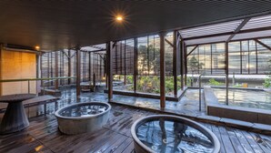 Amplio espacio interior con ventanas grandes, suelo de madera y dos jacuzzis.
