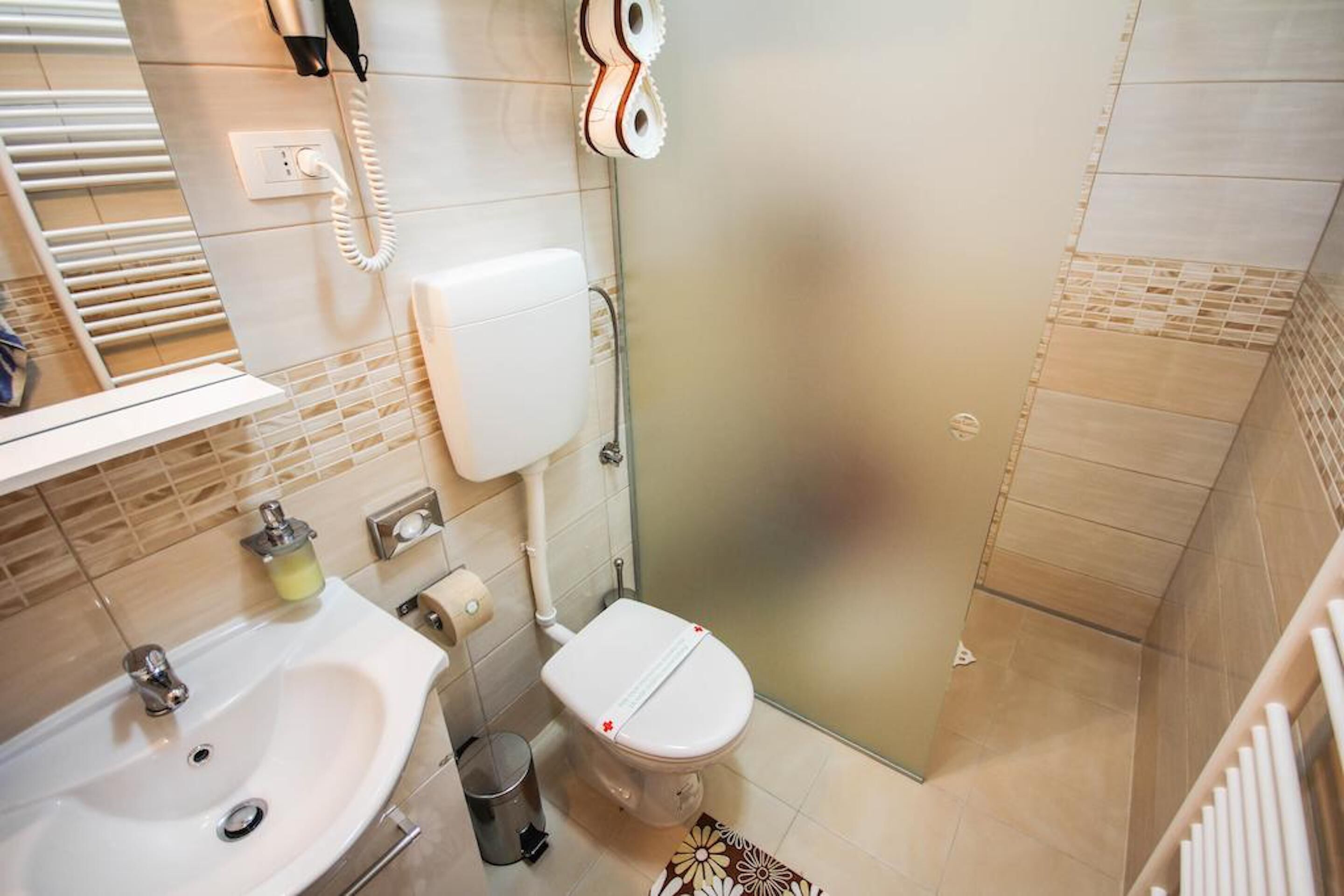 Ein Badezimmer mit Waschbecken, Toilette und Dusche.