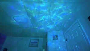 A room with a ceiling that has a light projection creating a pattern.