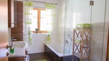 Separate bathtub and shower, hair dryer, towels