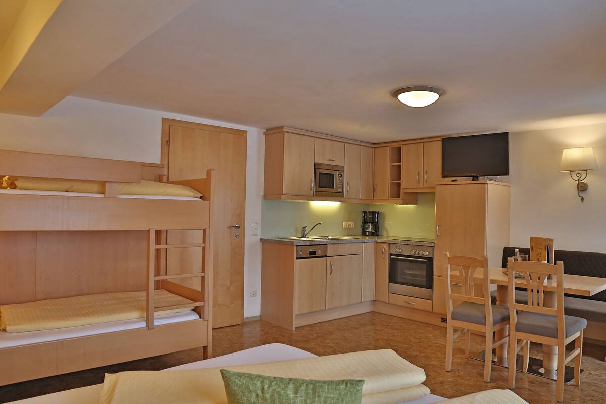 Apartment (Typ 1) | Living room | Flat-screen TV, toys