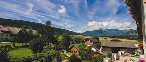 A scenic view of a village with houses, a playground, and a clear sky.