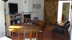 Un salon avec une cheminée, des meubles en bois et un téléviseur.