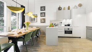 A modern kitchen with white cabinetry, a central island, and pendant lighting. - LivinParis | Luxury AC 4 Bedrooms Opera I (Paris)