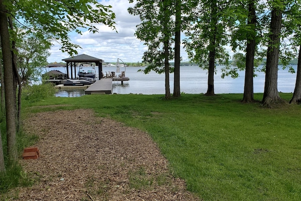 View of the permanent dock at the waters edge. Shady wooded area - very private