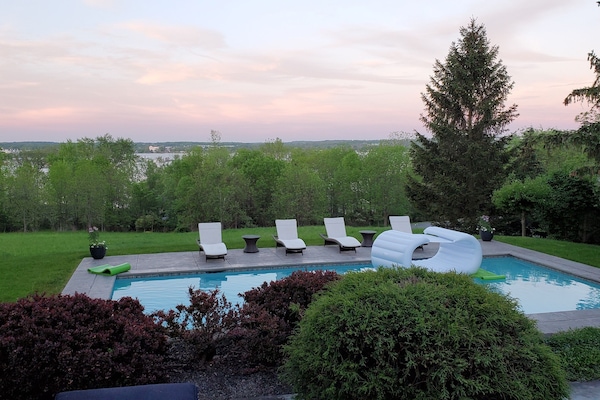 View from the kitchen looking to the pool and across the field to the lake.
