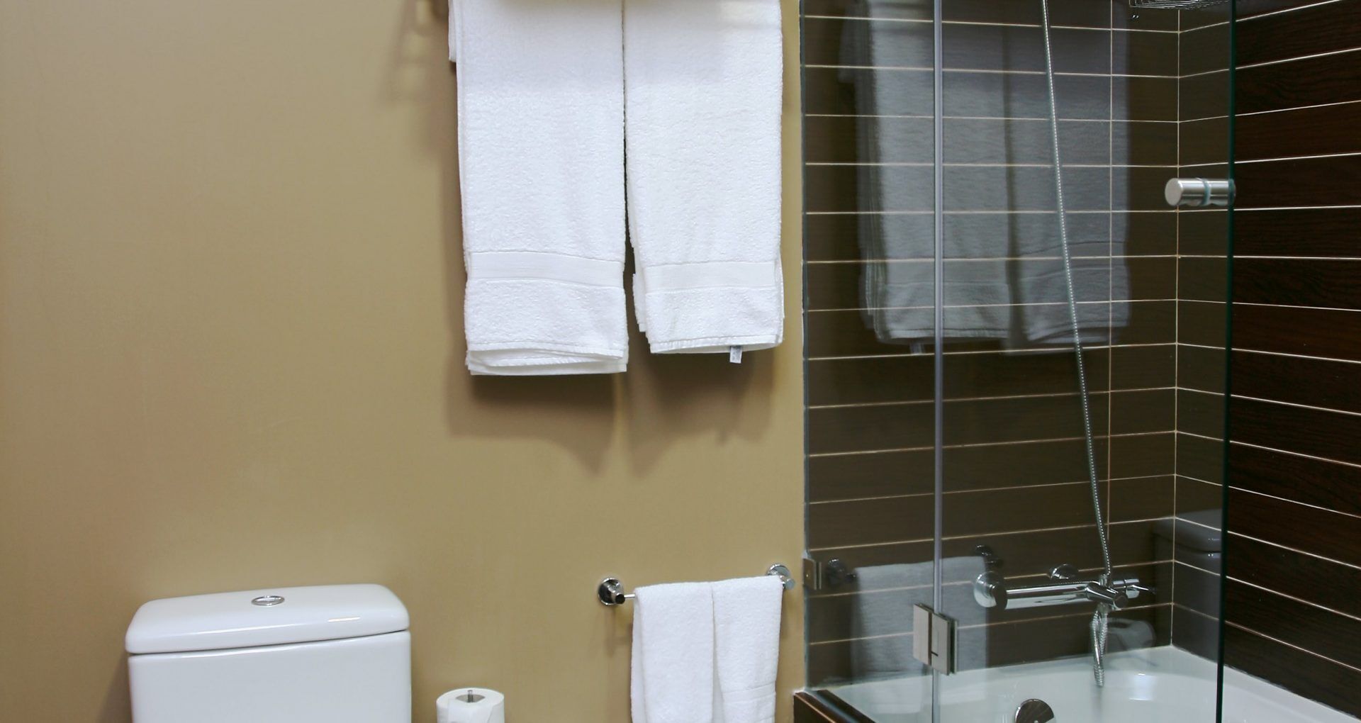 A bathroom with a toilet, a sink, and a shower area.