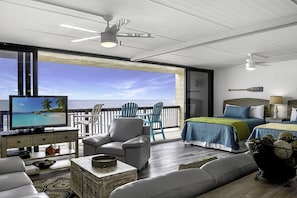 Enjoy ocean views from the large window in this stylish room, featuring a comfortable seating area and a flat-screen TV.