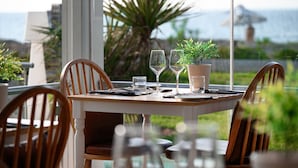 A table set for two with a view of the sea and a palm tree. - Restia (Corfu)