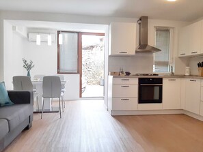 Apartment (One Bedroom Apartment) | Private kitchen | Fridge, cookware/dishes/utensils, cleaning supplies, freezer