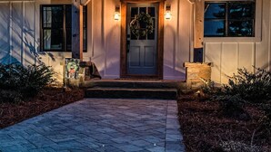 A house with a stone pathway leading to a wooden front door, flanked by two windows and a stone planter. - Farmhouse just minutes from Hanging Rock, sister property next door ID#3934130 (King)