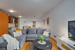 Leilighet – deluxe, 1 kingsize-seng med sovesofa, terrasse, sjøutsikt | Oppholdsområde | TV