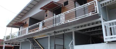 A multi-story building with a balcony on the second floor.