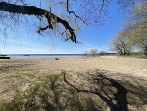 A beach with sparse vegetation and a clear sky. - (Hickory Cabin) Beautiful 3 Bedroom Cottage - Lakefront - Pets OK  (East Tawas)