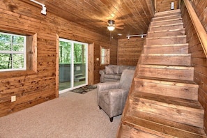 Step up to the upper level or relax on the sofa near the sliding door, which leads to a balcony.