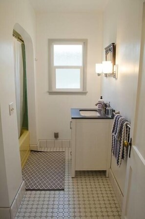 A small bathroom with a window, a sink, and a mirror. - Walk to Main St! 20 min drive to Whitney Portal. High speed internet (Lone Pine)