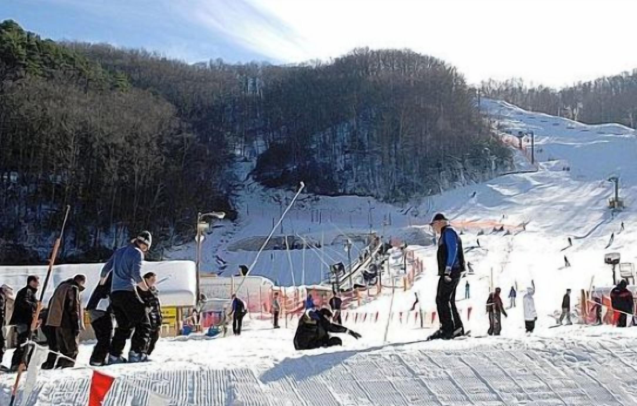 Une piste de ski où l’on voit des gens skier et se tenir debout.