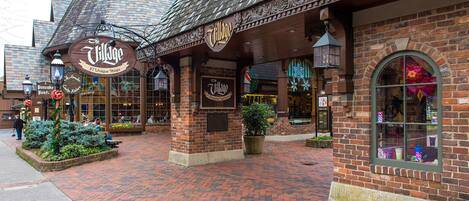 A brick building with a sign reading "Village 27 Unique Shops."