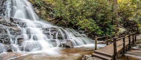 A waterfall with a wooden bridge.